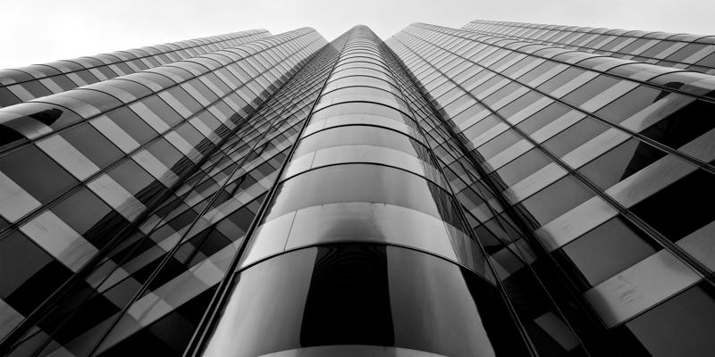 A low angle view of a tall building

Description automatically generated